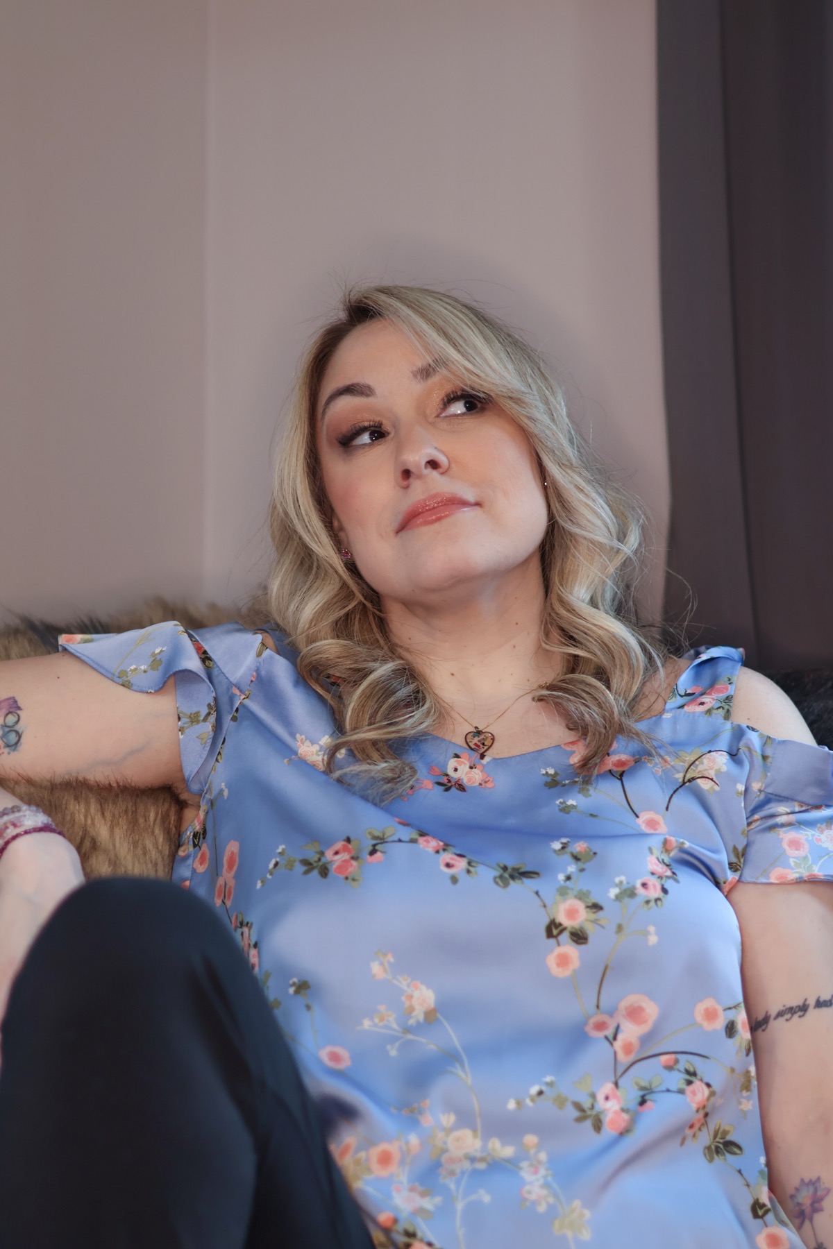 Contemplative portrait of Loren Galese in a blue floral top